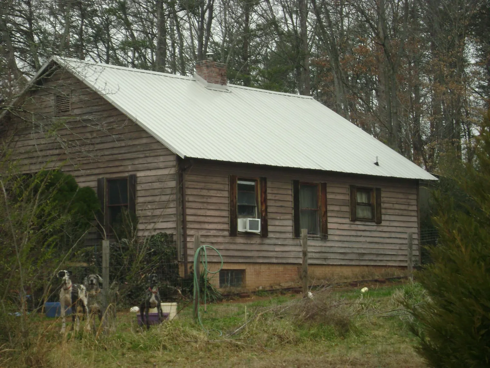 White metal roof on an old wood sided farmhouse, from a Metal Roof Installation job in Massapequa